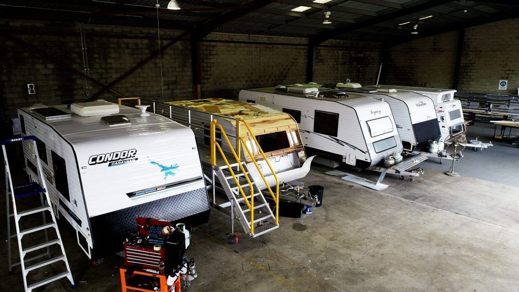 group of caravan inside repair shop